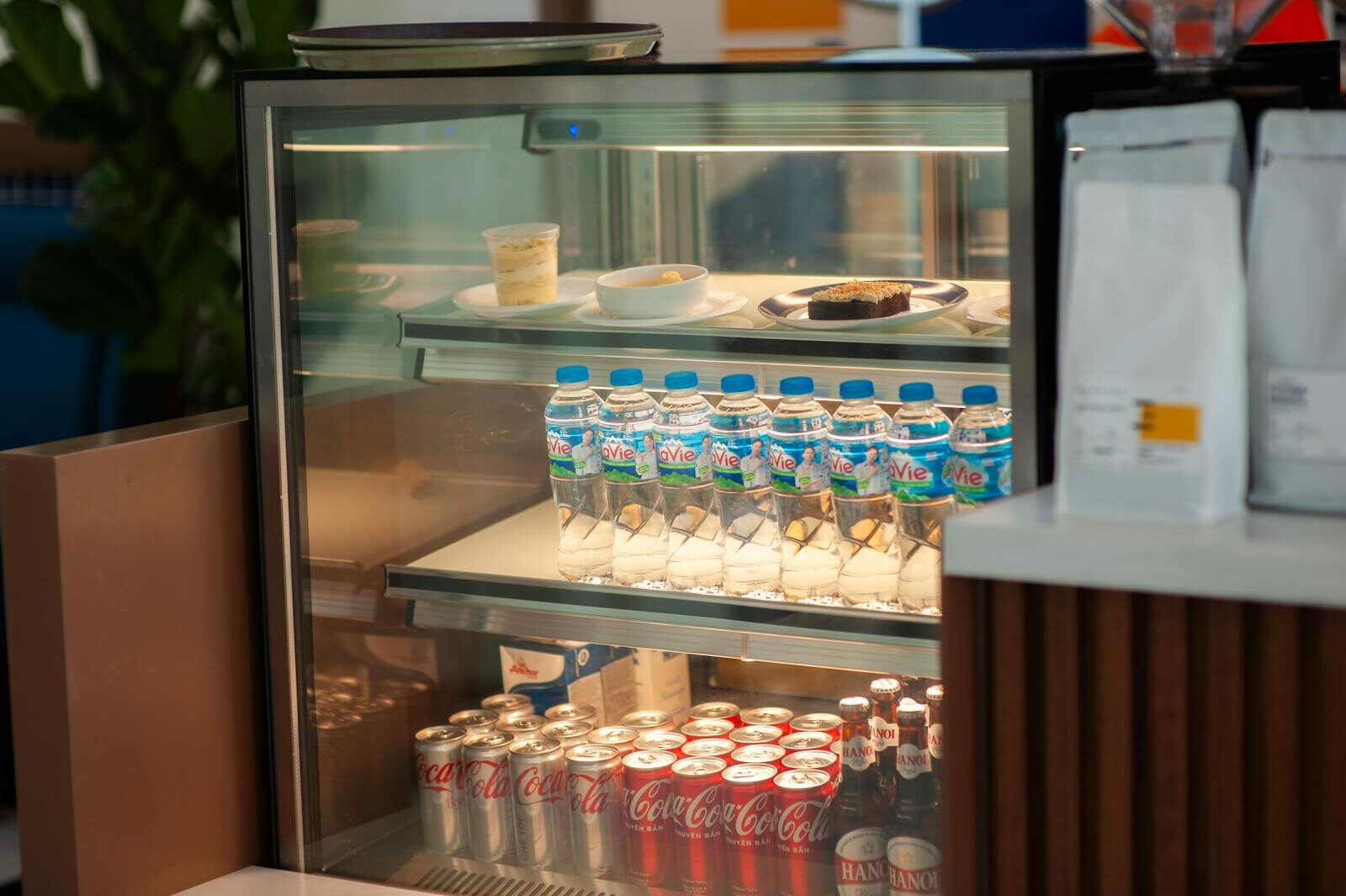 Chilled drinks and desserts in a cafe refrigerator, providing a refreshing selection.