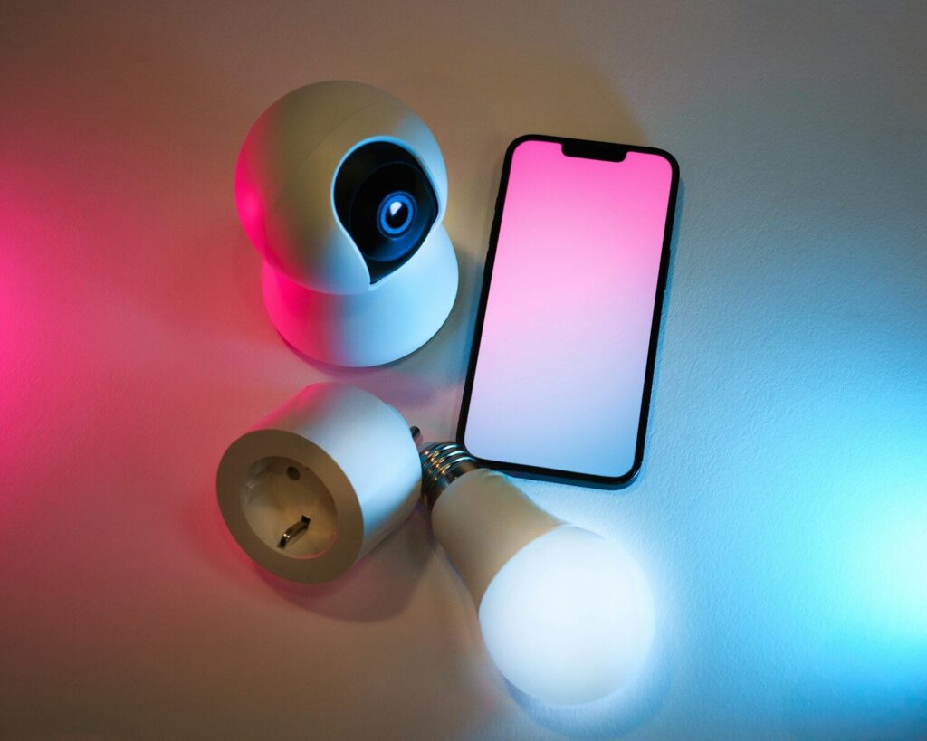 A smart phone sitting on top of a table next to a flashlight